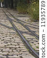 old tram rails on cobblestone 11935789