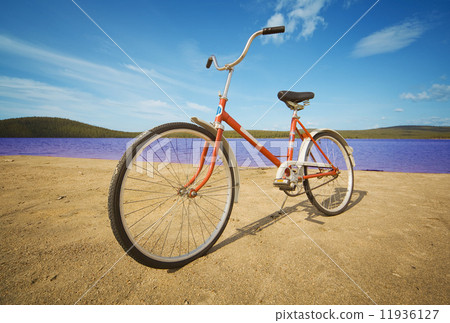 Old-fashioned bicycle on summer beach 11936127