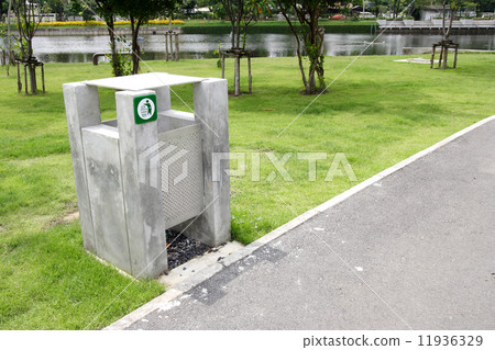 green garbage can on a garden grass background 11936329
