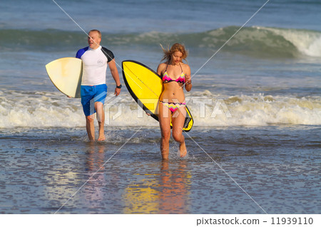 Surfers on Beach Having Fun in Summer. 11939110
