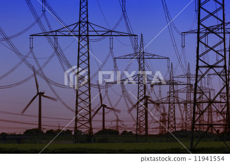 Wind Turbines behind Power Lines and a group of Power Towers 11941554