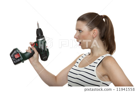 Young craftswoman shocked of a power drill Young craftswoman shocked of a power drill 11941558