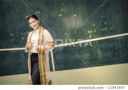The female graduation portrait in academic gown is looking forwa The female graduation portrait in academic gown is looking forwa 11941647