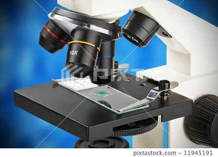 Close up of microscope lenses focused on a specimen Close up of microscope lenses focused on a specimen 11945191