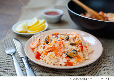 Spanish dish paella with seafood, shrimps in pan 11950312