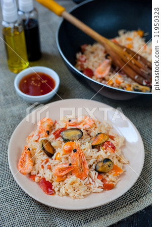 Spanish dish paella with seafood, shrimps in pan 11950328