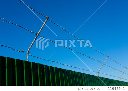 Barbed wire on fence 11952641