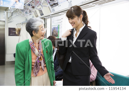 A woman giving a seat to the elderly A woman giving a seat to the elderly 11954134