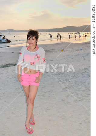 A young woman smiling at the beach 11956853