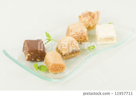 Baklava - Middle Eastern sweet pastry and nuts selection o an blue background. 11957711