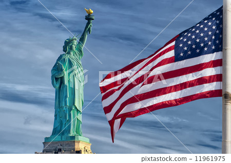 Usa American flag stars and stripes on statue of liberty blue sky background Usa American flag stars and stripes on statue of liberty blue sky background 11961975