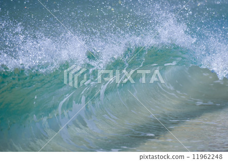A wave smashing on the sand shore A wave smashing on the sand shore 11962248