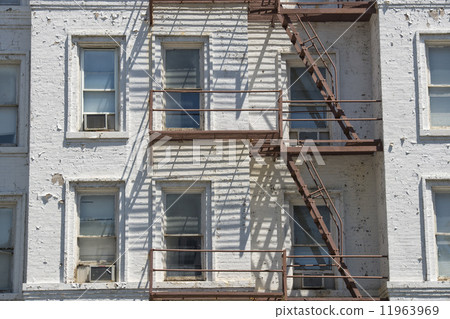 Rusted Fire ladder on abandoned building in New York 11963969