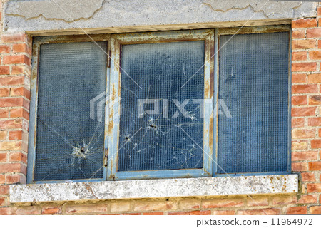 bullet holes on glass window 11964972