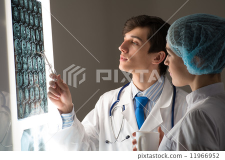 medical colleagues confer near the x-ray image medical colleagues confer near the x-ray image 11966952