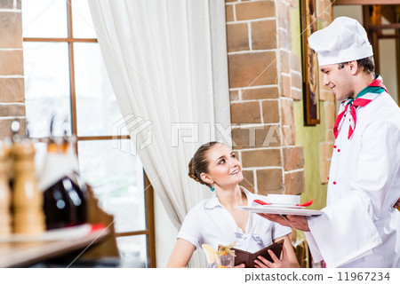 Chef brings a dish pretty woman in a restaurant Chef brings a dish pretty woman in a restaurant 11967234