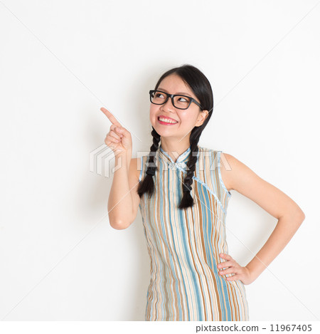 Asian Chinese girl pointing on blank copy space 11967405