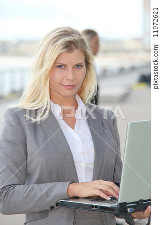 Closeup of businesswoman attending exhibition Closeup of businesswoman attending exhibition 11972621