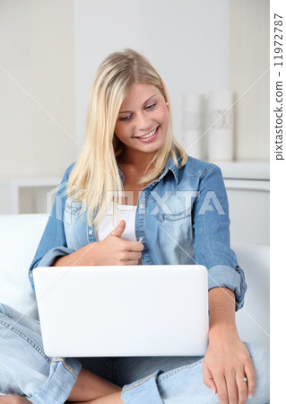 Blond woman at home connected on internet 11972787
