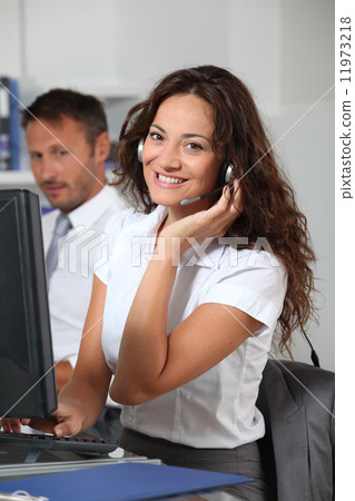 Businesswoman  answering the phone in the office 11973218