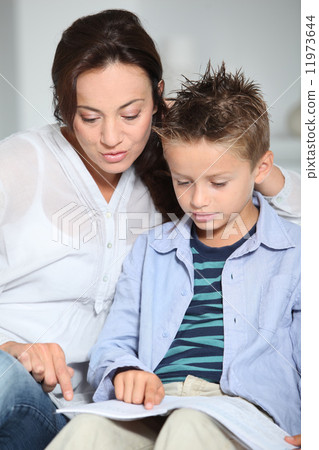 Mother helping son with homework Mother helping son with homework 11973644