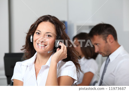 图库照片: businesswoman answering the phone in the office