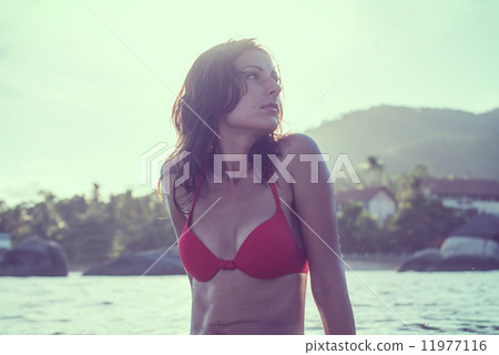 Outdoor summer portrait of young pretty woman girl in red bikini swimsuit on the beach tropic island Outdoor summer portrait of young pretty woman girl in red bikini swimsuit on the beach tropic island 11977116