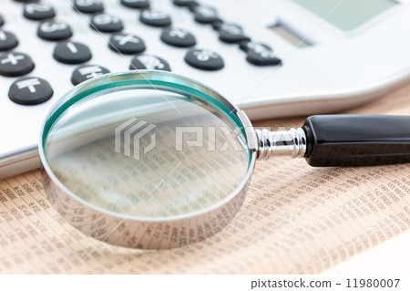 financial newspaper with calculator and magnifier financial newspaper with calculator and magnifier 11980007