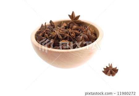 anise stars in a wood bowl 11980272