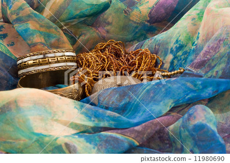 two bracelets and a necklace on a multicolored silk two bracelets and a necklace on a multicolored silk 11980690