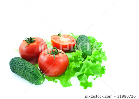 two and half tomatos and two cucumbers on leaves of lettuce 11980720