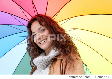 Woman holding colorful umbrella 11985537