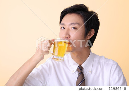 A beverage drinking office worker A beverage drinking office worker 11986346