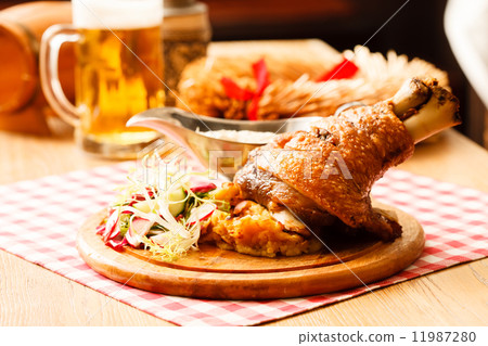 eisbein with braised cabbage, salad and beer 11987280