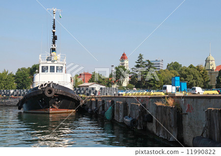 Black tug with white superstructure stands in Burgas 11990822