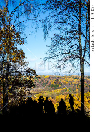 Picturesque autumn landscape and tourists silhouettes 11991052