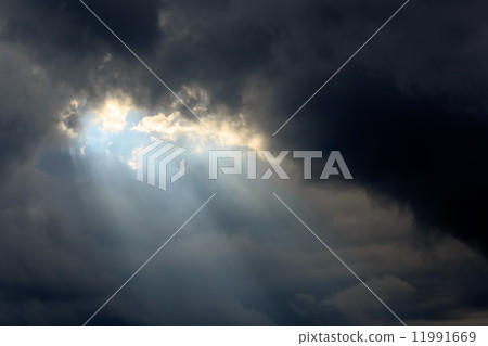 Sun Beam in Dark Clouds and Sky 11991669
