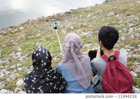 Asian who takes pictures at the park Asian who takes pictures at the park 11994238