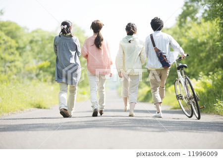A rear view of a university student walking on a single road A rear view of a university student walking on a single road 11996009