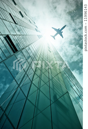 plane flying over office building 11996143