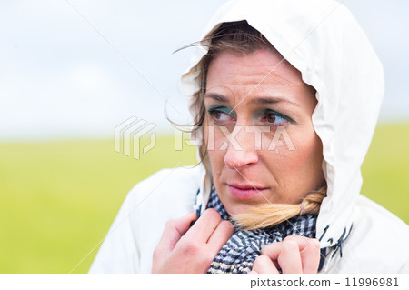 Woman in rain shower at sea coast 11996981