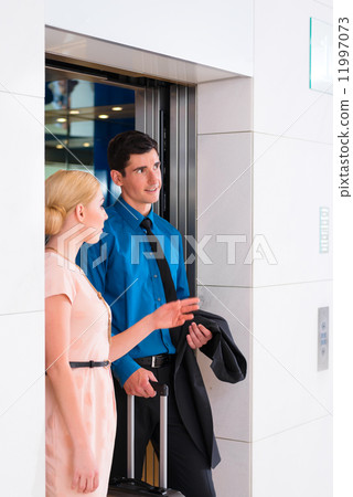 Couple waiting for hotel elevator or lift Couple waiting for hotel elevator or lift 11997073