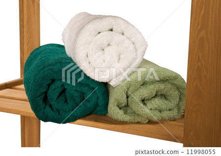 stack of twisted terry towels on a shelf isolated on white background 11998055