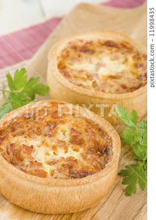 Quiche Lorraine - Individual quiches with bacon, cheese and savoury custard. Quiche Lorraine - Individual quiches with bacon, cheese and savoury custard. 11998435