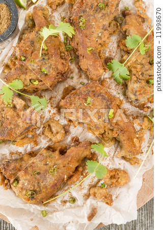 Mutton Chaap - Fried battered spicy lamb cutlets garnished with green chilies and coriander. 11998670