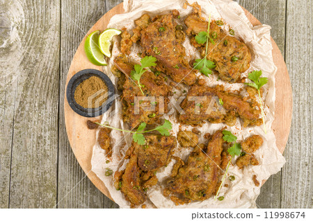 Mutton Chaap - Fried battered spicy lamb cutlets garnished with green chilies and coriander. 11998674