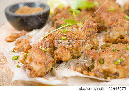 Mutton Chaap - Fried battered spicy lamb cutlets garnished with green chilies and coriander. 11998675