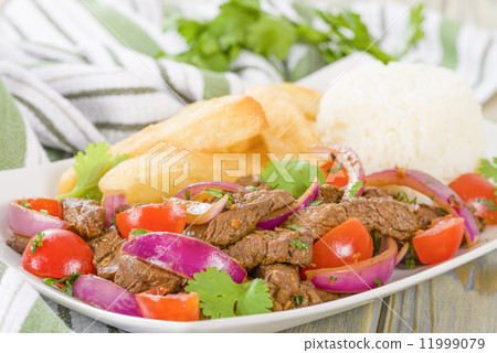 Lomo Saltado - Traditional Peruvian stir-fry with beef, red onions, tomatoes and fries Lomo Saltado - Traditional Peruvian stir-fry with beef, red onions, tomatoes and fries 11999079