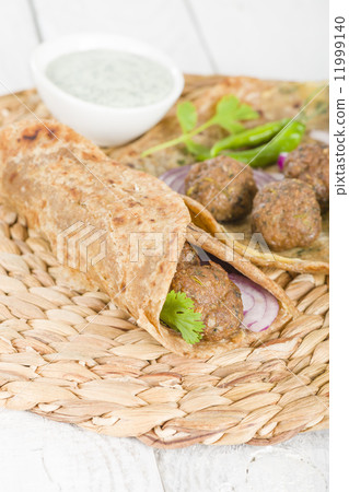 Kati Roll - Kofta kebabs and red onion pickle rolled in a paratha fried with eggs. Kati Roll - Kofta kebabs and red onion pickle rolled in a paratha fried with eggs. 11999140