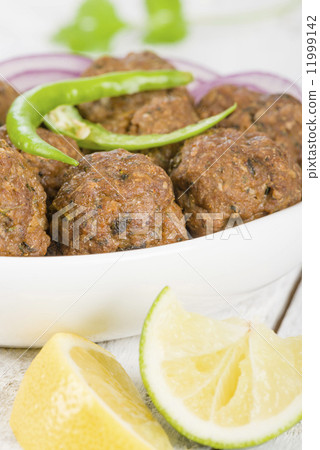 Kofta - South Asian spicy meatballs garnished with green chilies and red onions. Kofta - South Asian spicy meatballs garnished with green chilies and red onions. 11999142